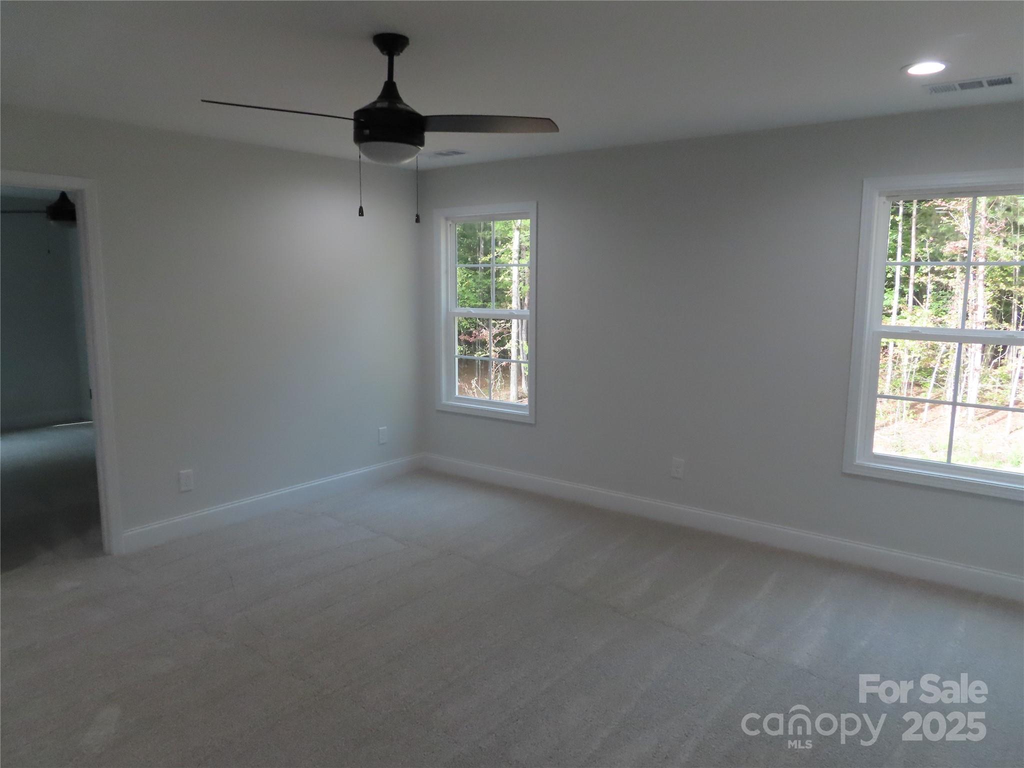 2099 Cedar Road York, SC 29745 - Photo 33 of 37 an empty room with windows and ceiling fan