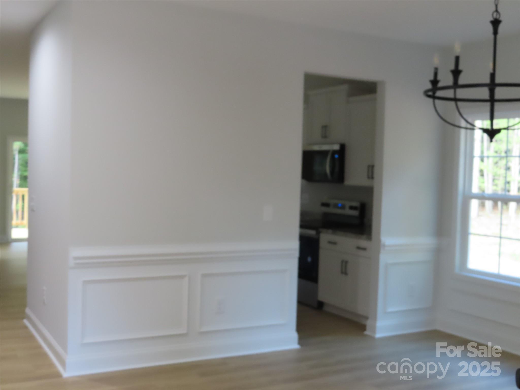 2099 Cedar Road York, SC 29745 - Photo 9 of 37 a kitchen with white cabinets and a wooden floor