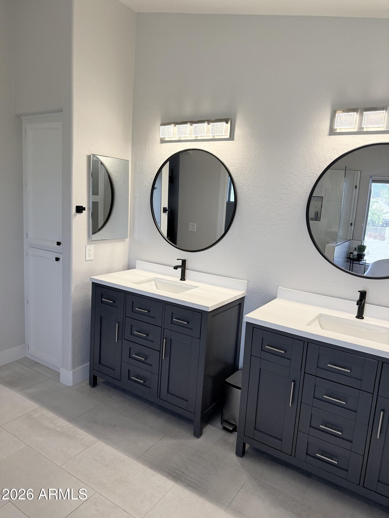 3426 East Clark Road Phoenix, AZ 85050 - Photo 24 of 48 a bathroom with a double vanity sink and mirror