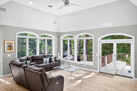 a living room with furniture and large windows
