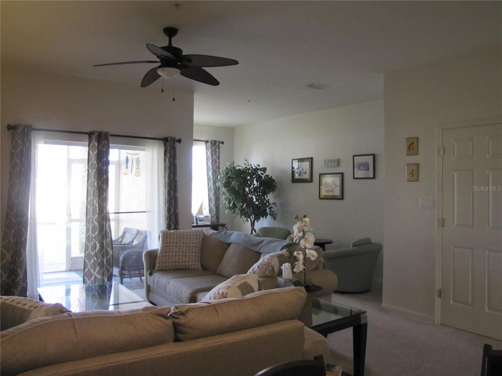 3461 Parkridge Circle, Unit 18104 Sarasota, FL 34243 - Photo 11 of 35 a living room with furniture and a window