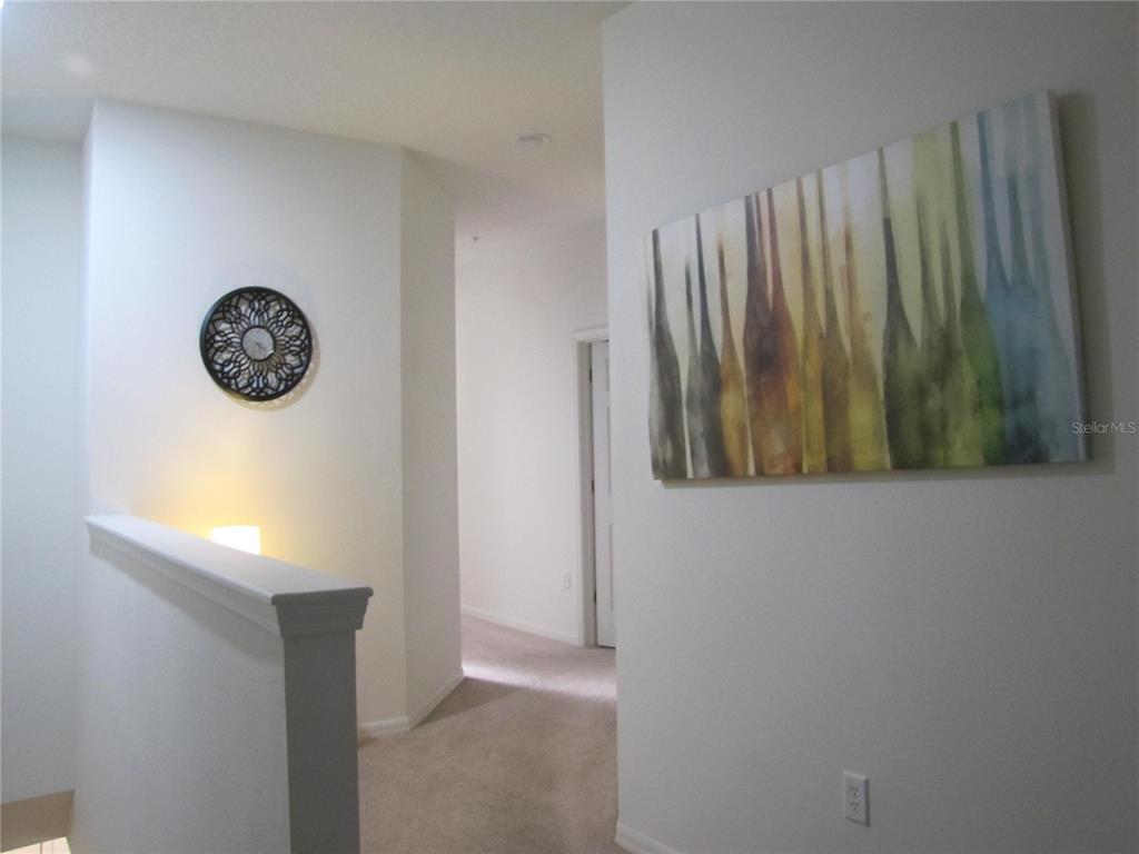 3461 Parkridge Circle, Unit 18104 Sarasota, FL 34243 - Photo 14 of 35 a view of a closet with wooden floor