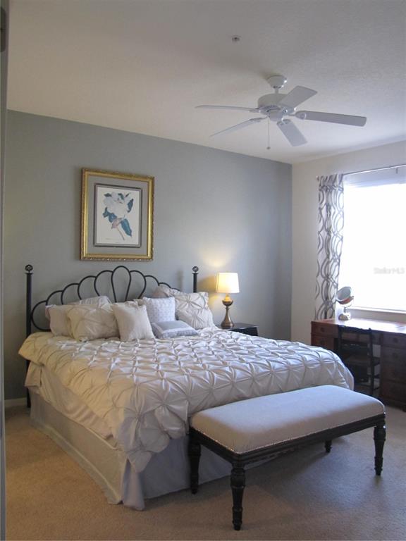 3461 Parkridge Circle, Unit 18104 Sarasota, FL 34243 - Photo 16 of 35 a bedroom with a bed and window