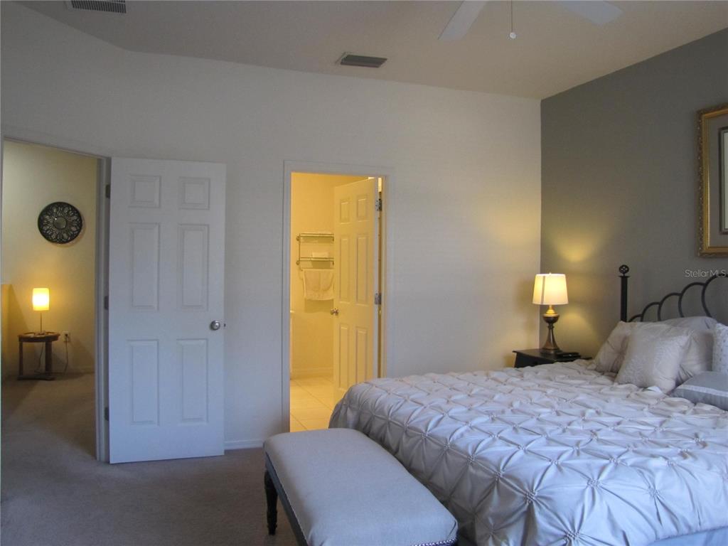 3461 Parkridge Circle, Unit 18104 Sarasota, FL 34243 - Photo 17 of 35 a bedroom with a bed and a closet