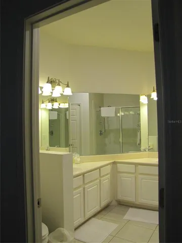 a bathroom with a glass shower door