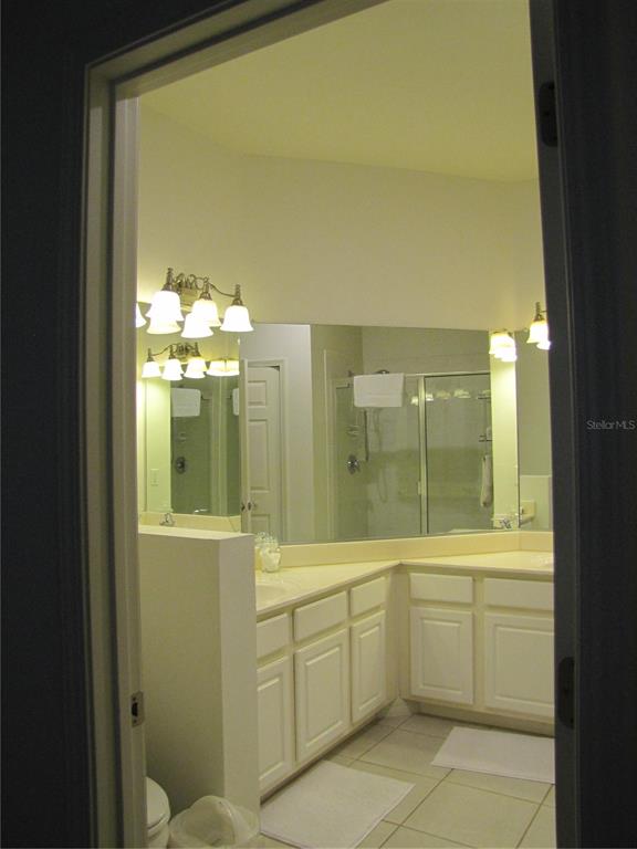 3461 Parkridge Circle, Unit 18104 Sarasota, FL 34243 - Photo 19 of 35 a bathroom with a sink mirror and a shower
