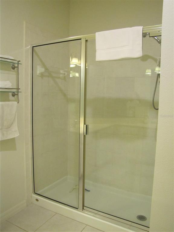 3461 Parkridge Circle, Unit 18104 Sarasota, FL 34243 - Photo 20 of 35 a bathroom with a glass shower door