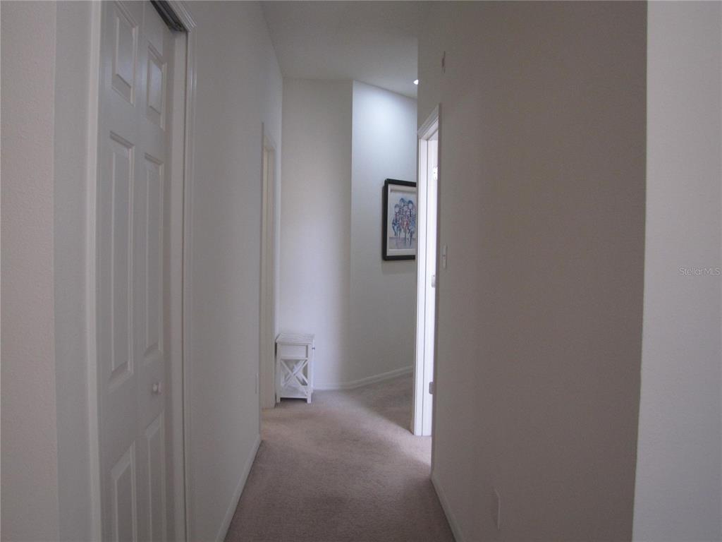 3461 Parkridge Circle, Unit 18104 Sarasota, FL 34243 - Photo 21 of 35 a view of a hallway with wooden floor