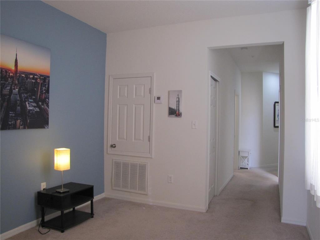 3461 Parkridge Circle, Unit 18104 Sarasota, FL 34243 - Photo 22 of 35 a room with a bed and a lamp on table