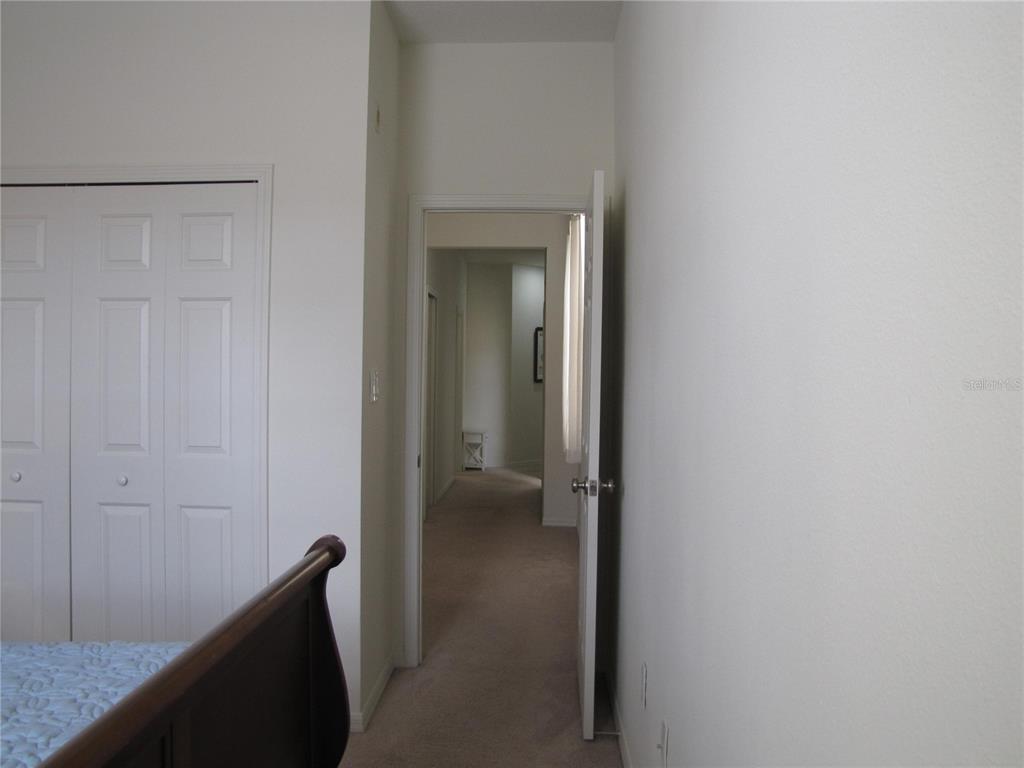 3461 Parkridge Circle, Unit 18104 Sarasota, FL 34243 - Photo 24 of 35 a view of a hallway with wooden shelves