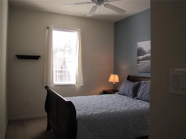 a bedroom with a bed and window