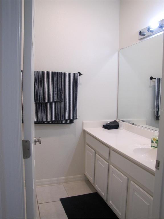 3461 Parkridge Circle, Unit 18104 Sarasota, FL 34243 - Photo 30 of 35 a bathroom with a sink and a mirror