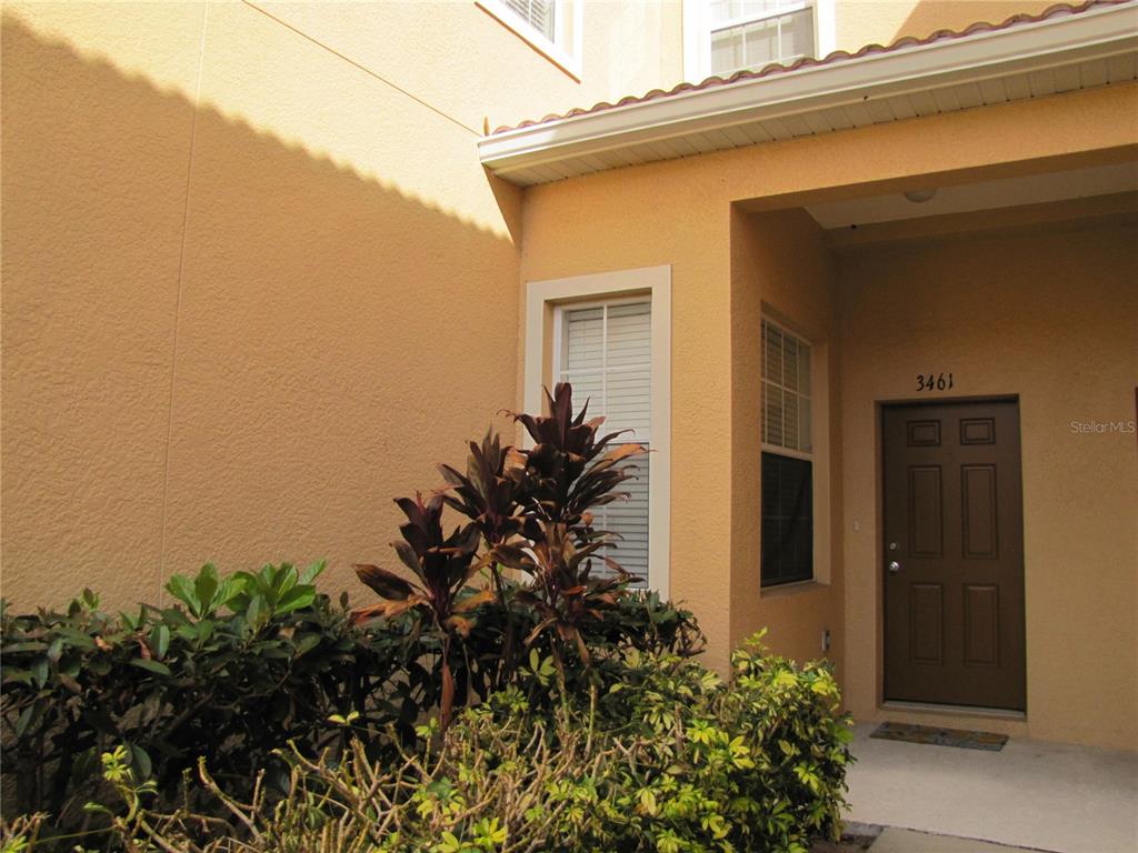 3461 Parkridge Circle, Unit 18104 Sarasota, FL 34243 - Photo 3 of 35 front view of a house with a small yard