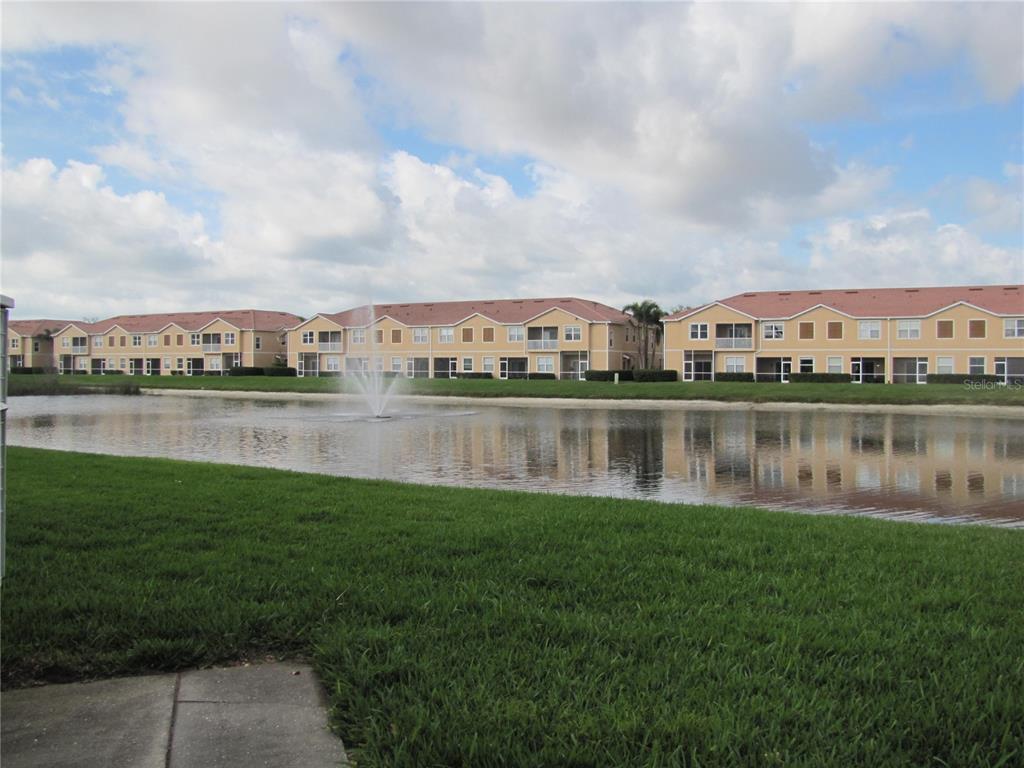 3461 Parkridge Circle, Unit 18104 Sarasota, FL 34243 - Photo 33 of 35 a view of a lake with houses in the back
