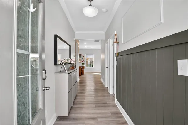 a view of a hallway with wooden floor and staircase