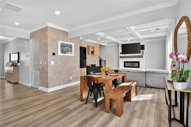 a view of a dining room with furniture window and wooden floor
