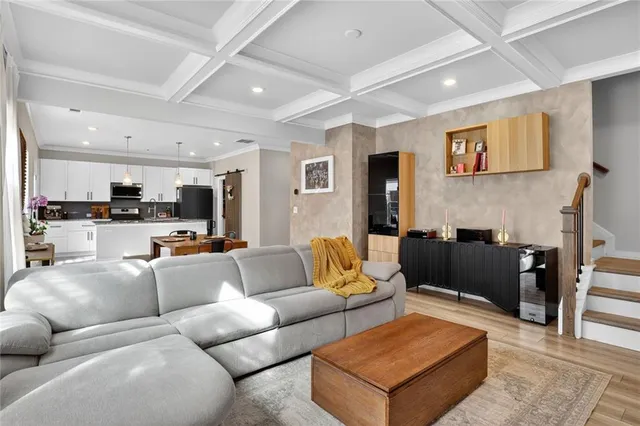 a living room with furniture kitchen view and a couch