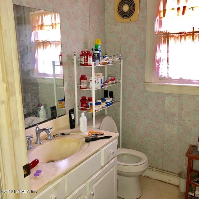 11626 Brady Road Jacksonville, FL 32223 - Photo 38 of 39 a bathroom with a sink vanity mirror and toilet