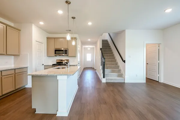 a kitchen with a stove top oven and sink