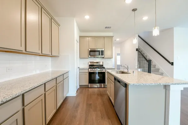 a view of a kitchen with a sink and a refrigerator