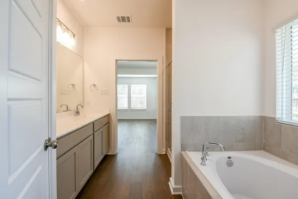an empty room with a ceiling fan and window