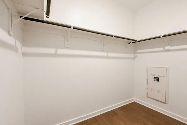 an empty room with a window and a ceiling fan