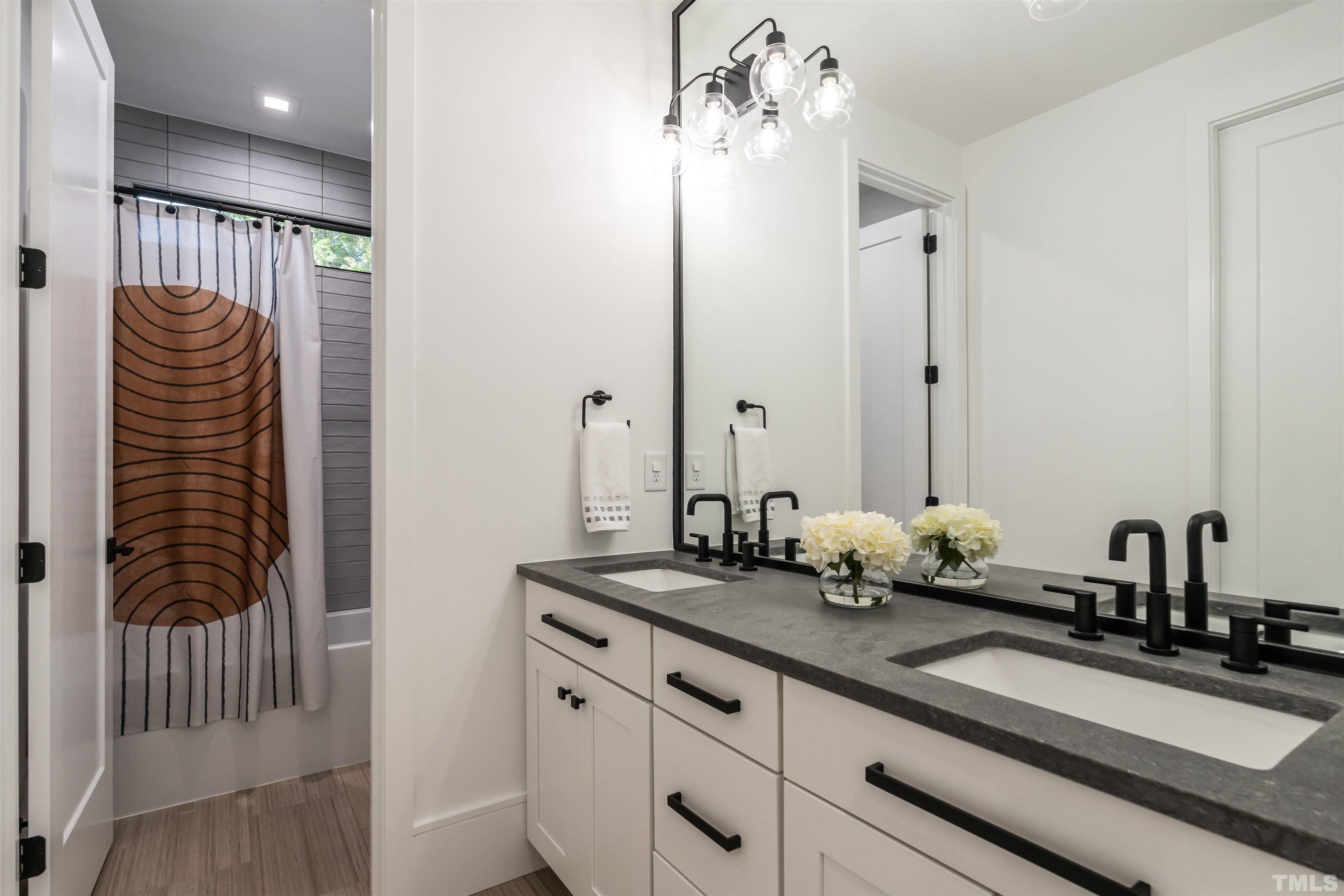 628 Sasser Street Raleigh, NC 27604 - Photo 36 of 45 a bathroom with a sink a mirror and vanity