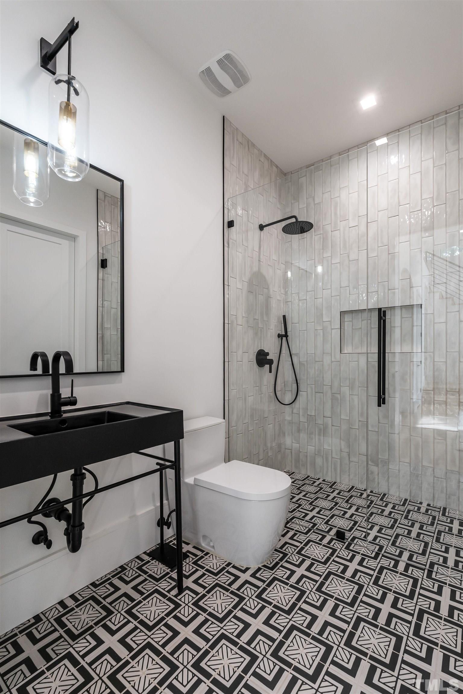 628 Sasser Street Raleigh, NC 27604 - Photo 7 of 45 a bathroom with a sink toilet a mirror and shower