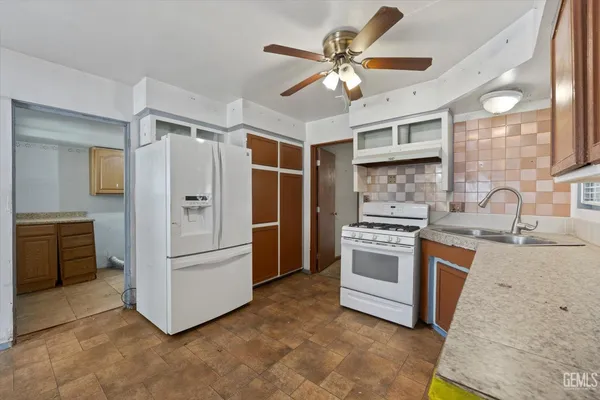 a kitchen with stainless steel appliances granite countertop a stove a refrigerator and a sink