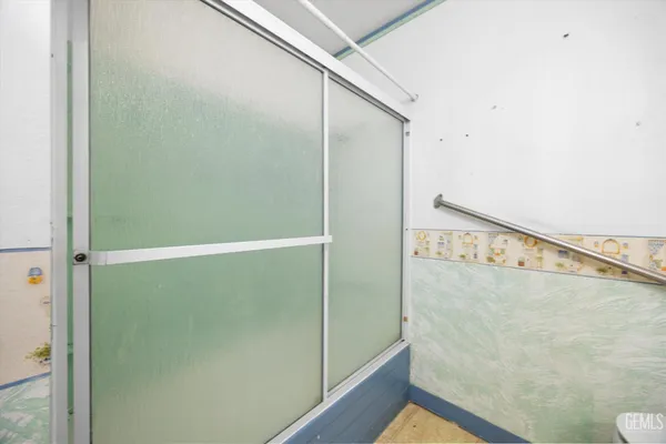 a bathroom with a glass shower door