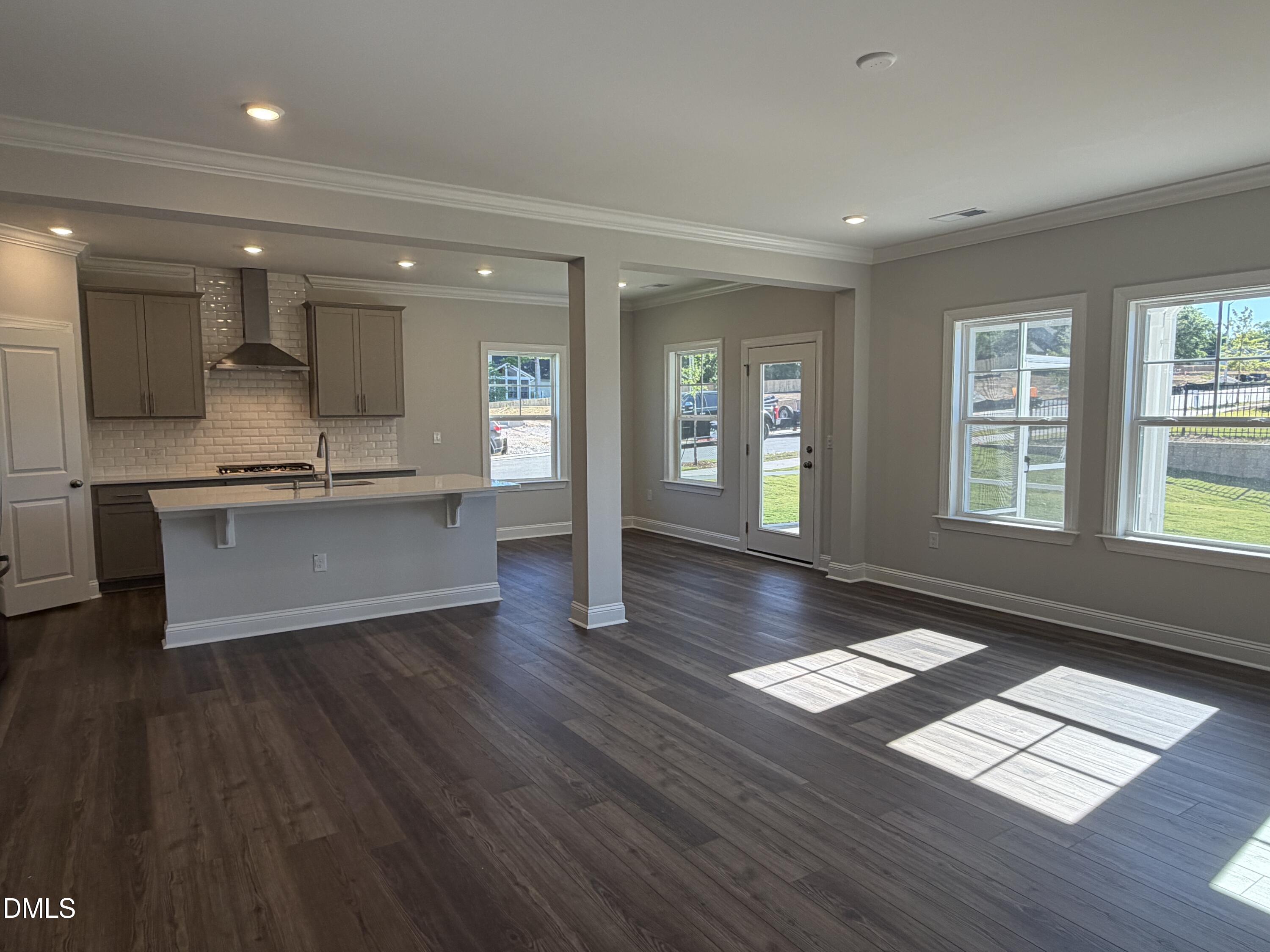 3016 Sandy Bluff Road Raleigh, NC 27616 - Photo 9 of 34 a view of an empty room with window and wooden floor