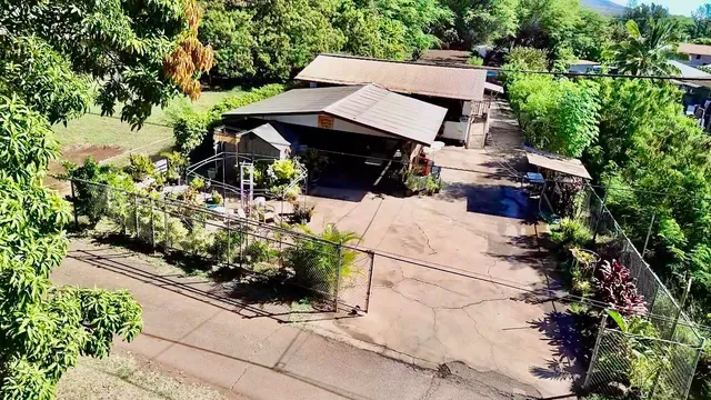 an aerial view of a house with a yard and garden