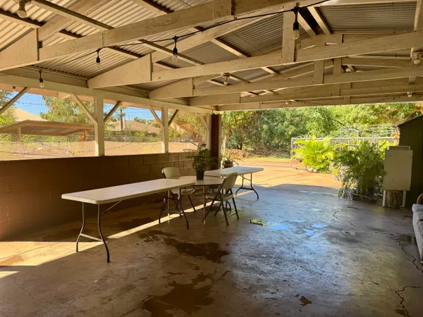 a view of a patio with a table and chairs