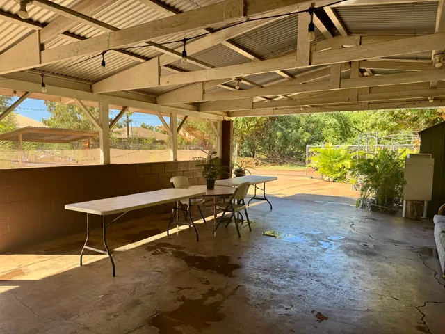 a view of a patio with a table and chairs