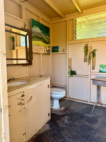 a bathroom with a sink a toilet and a window