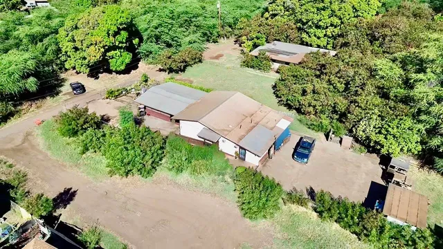 an aerial view of a house with yard