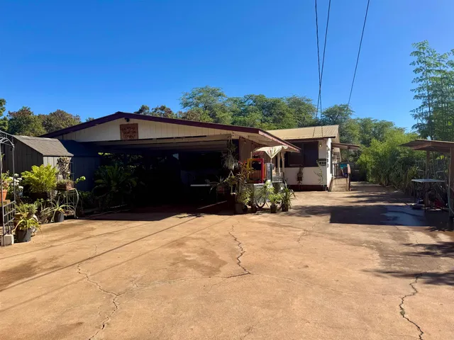 a view of house with outdoor space and sitting area