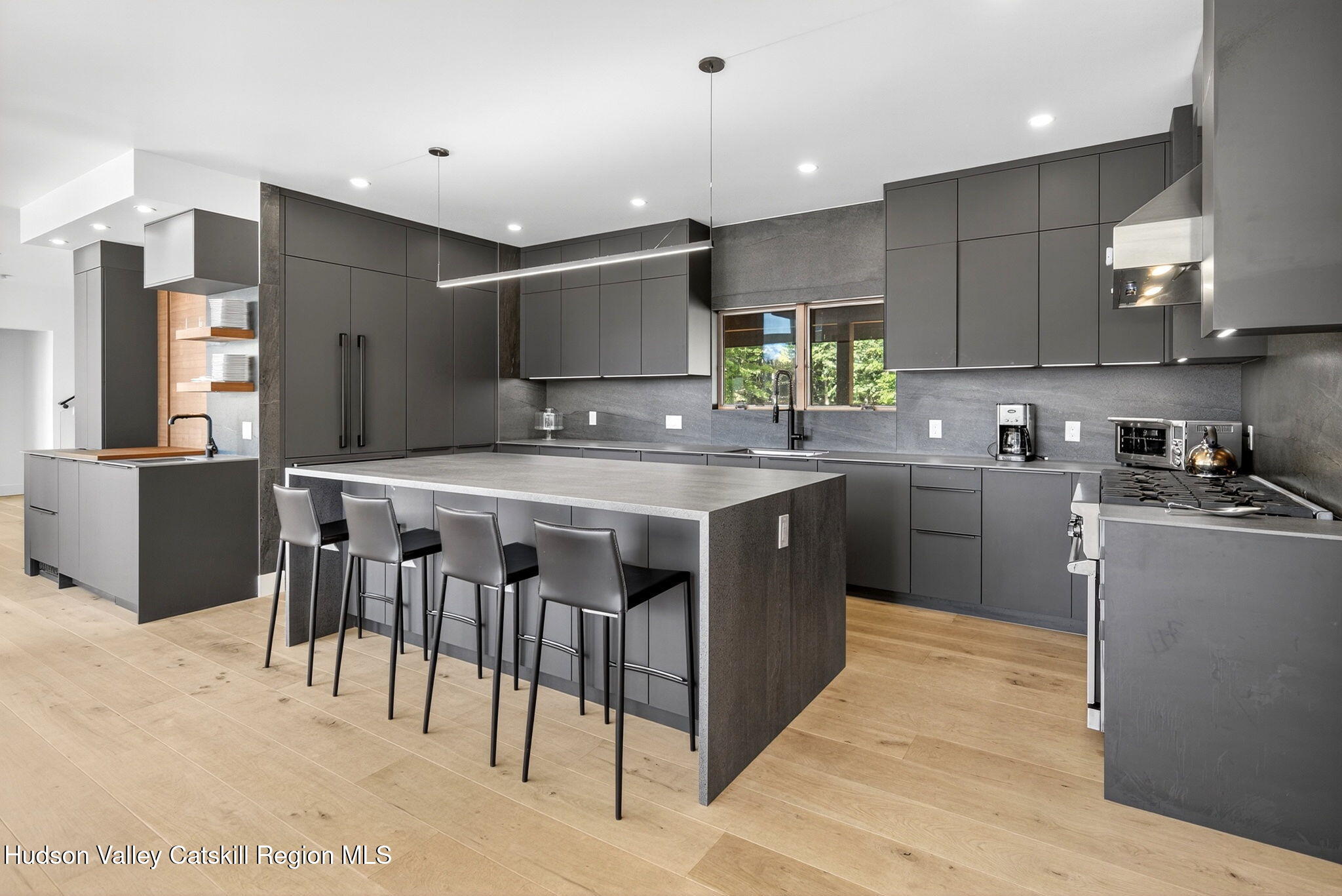 110 Old Road Windham, NY 12496 - Photo 16 of 66 a kitchen with stainless steel appliances kitchen island granite countertop a table chairs sink and cabinets