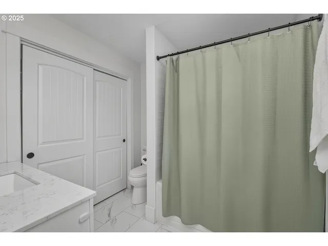 a bathroom with a shower curtain and a sink