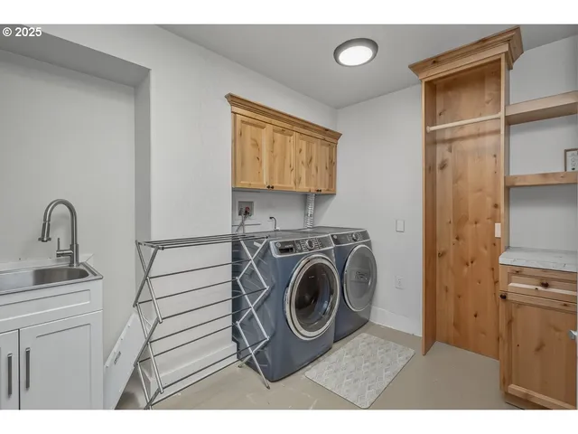 a utility room with sink dryer and washer