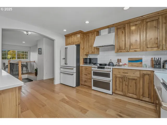 a kitchen with a refrigerator sink and cabinets