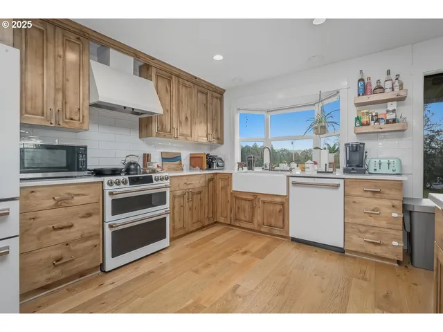 a kitchen with stainless steel appliances a sink and cabinets
