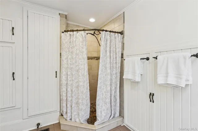a bathroom with a shower and a glass door