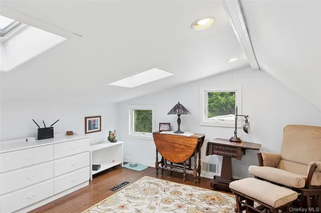a bedroom with a bed wooden floor and window