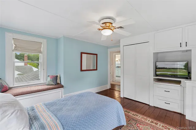 a bathroom with a sink a toilet and a window