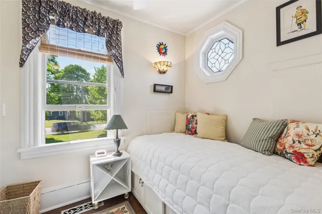 a view of a room that has a window and wooden floor