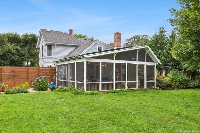a view of a house with a yard porch and sitting area