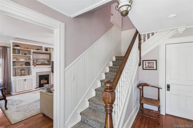 a view of entryway and hall with wooden floor