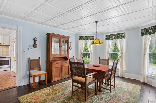 a dining room with furniture window wooden floor