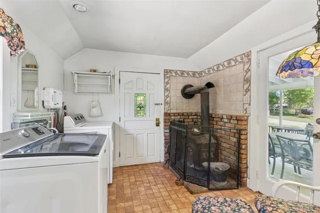 a kitchen with stainless steel appliances kitchen island granite countertop a sink stove and refrigerator